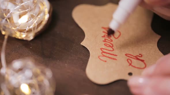 Time lapse. Handwriting gift tag for traditional home made gingerbread cookies.