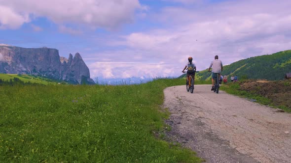 Couple Men and Woman on Vacation in the Dolomites ItalyAlpe Di Siusi  Seiser Alm South Tyrol Italy