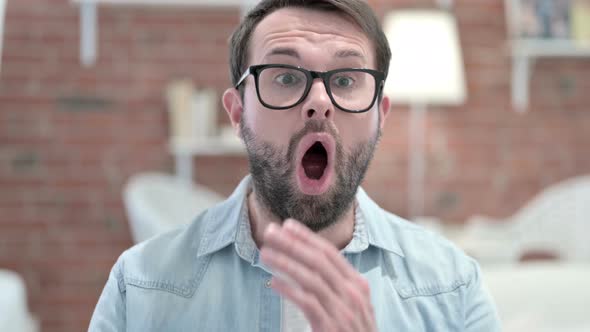 Portrait of Beard Young Man Shouting with Anger in Loft Office 