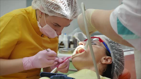 Close Up Female Hands Professional Doctor Stomatologist at Work. Person Undergoes a Medical