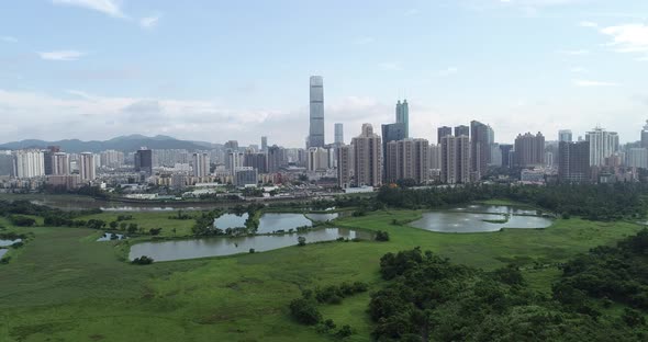 Rural green fields with fish ponds between Hong Kong and skylines of Shenzhen,China