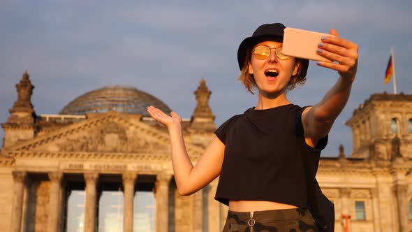 Young Woman Traveler Taking Selfie With Phone At Tourist Attraction Traveling in Europe.