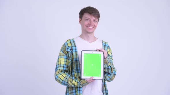 Happy Young Handsome Man Showing Digital Tablet