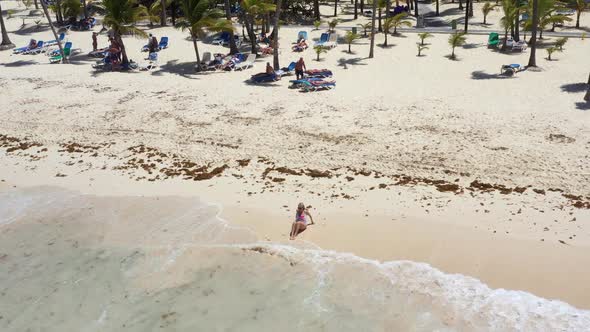 Aerial View From Drone on Caribbean Sea Beach with Woman Walking Along Shore