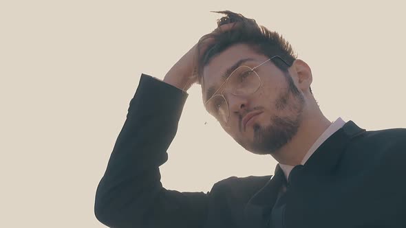 Man in Glasses Fixes Hair Waving in Wind Slow Motion