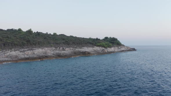 Aerial wide shot of the southern end of the famous Cape Kamenjak, Croatia. Drone flies slowly to the