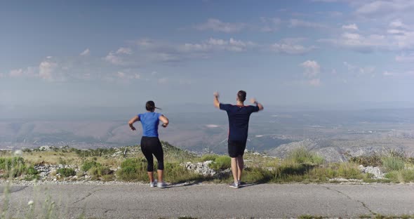 Athletic Man and Woman Celebrate Successful Run