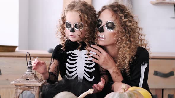 Portrait of Mother and Daughter with Curly Hair Wearing Costumes