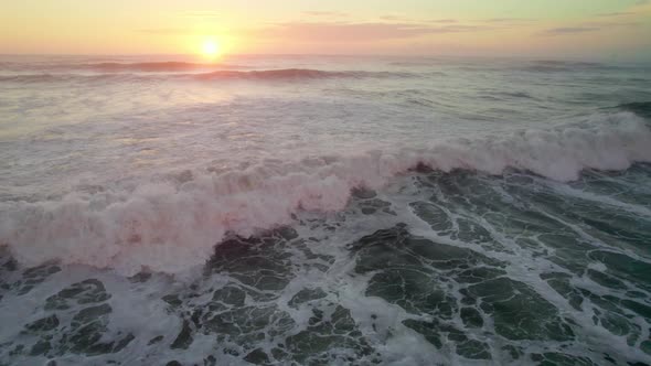 Flying Over the Ocean Wave During Sunset