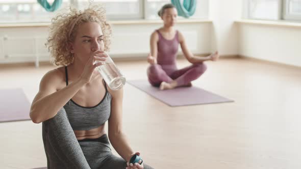 Woman Drinking Water on Yoga Lesson