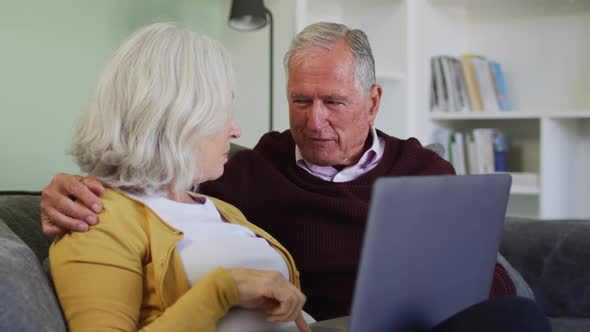 Senior caucasian couple using laptop computer together