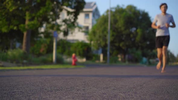 Slow Motion Shot of a Young Man Running Barefoot