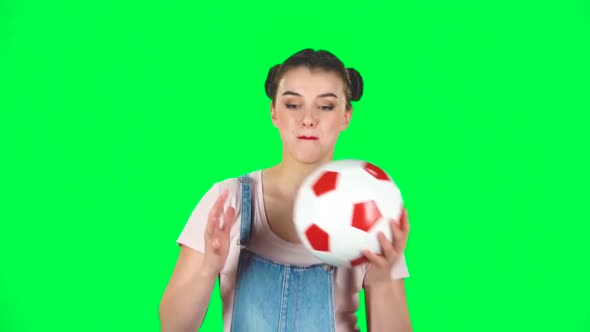 Cute Young Girl Playing with White-red Football Ball on Green Screen, Slow Motion