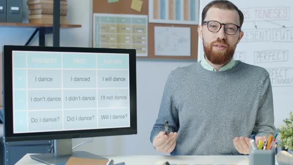 Portrait of School Teacher Working Online Speaking and Pointing at Computer Screen During Quarantine alt