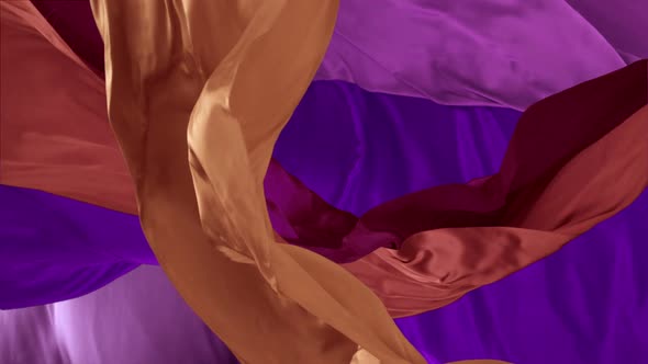 Various colored fabrics flying in midair, Slow Motion alt