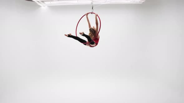 Beautiful Gymnast Spins On A Aerial Hoop In The Arch Of The Back