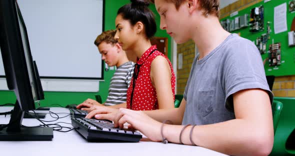 Students studying on computer in classroom