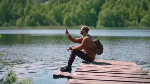 Brave Man Taking Photograph in Forest Lake with Smartphone Photographing Scenic Landscape Nature