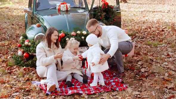 Mom with Dad and Two Daughters at a Christmas Photo Shoot