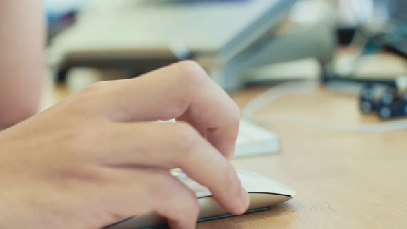 man hand working with wireless mouse on a desk