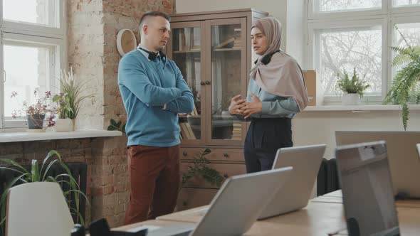 Male and Female Call Center Agents Chatting at Work