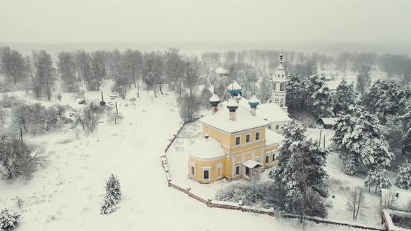 Festive Winter Village Landscape with Wooden Houses and a Church Aerial View