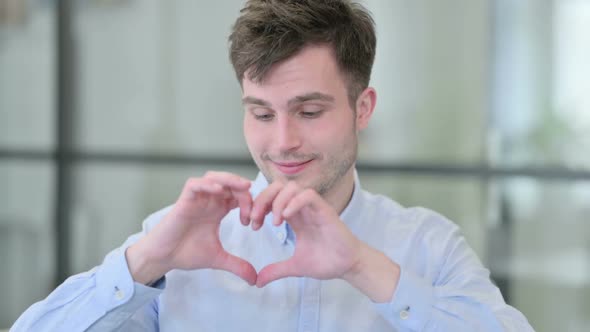 Young Man Showing Heart Sign By Hand