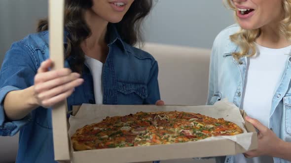 Cheerful Roommates Opening Box With Pizza, Girls Enjoying Aroma, Hen Party