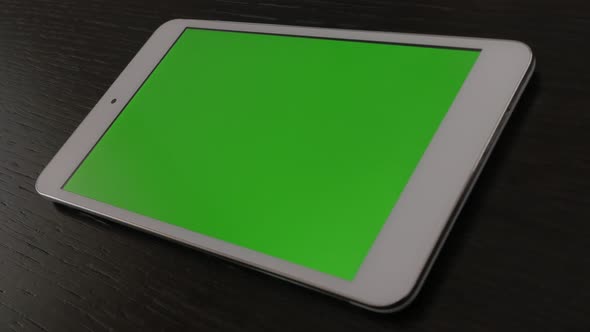 Greenscreen display tablet computer on table panning 4K 2160p 30fps UltraHD footage - Close-up of ch