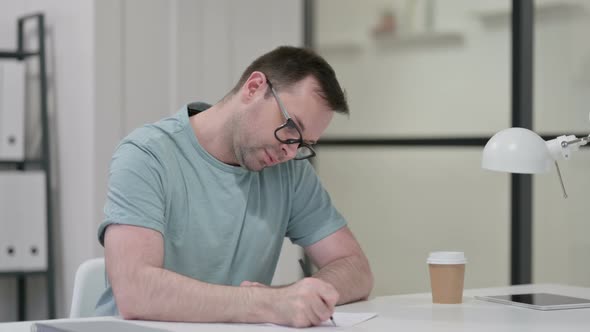 Pensive Young Man Writing Paper Thinking