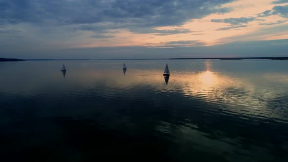 Aerial Drone Footage of Peaceful Scene with Yachts Cruising at Calm Water at Dusk