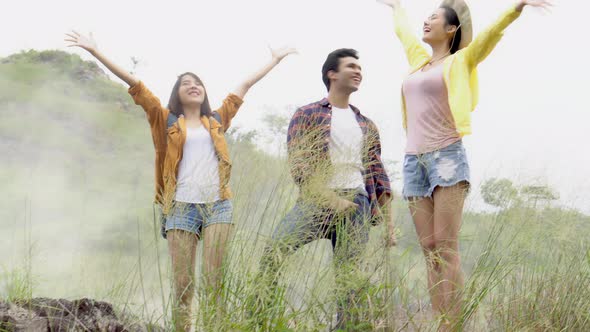 Happy group of friends walking in countryside in summer.