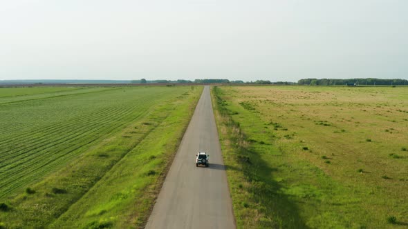 Aerial View of a Car Driving on a Country Road