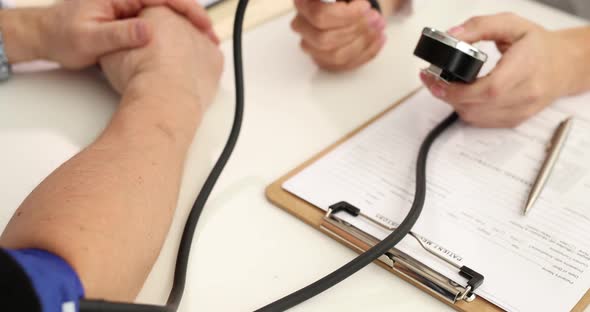 Doctor Cardiologist Measuring Blood Pressure to Patient at Clinic  Movie