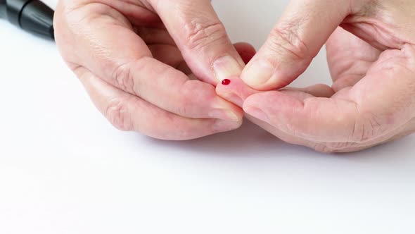 Female hands taking blood sample for blood sugar testing. 