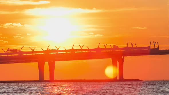 Bridge Over River Lit By Orange Setting Sun Light Timelapse