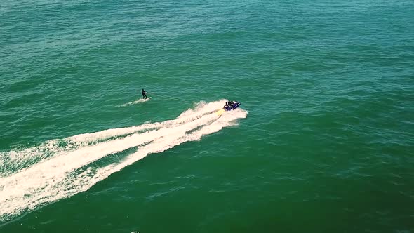 Aerial view of a surfer being towed with a jet ski near Cape Town, South Africa.