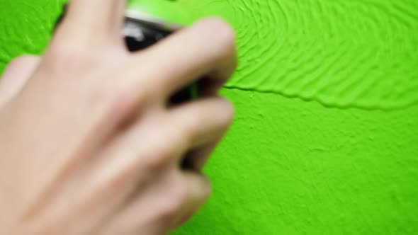 Painting Walls with Yellow Paint Using Brush Closeup