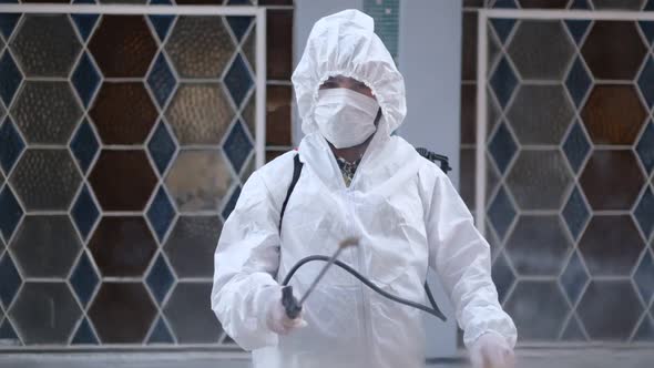 Civil defense team in protective clothing disinfects workplaces as a coronavirus (Covid-19) measure
