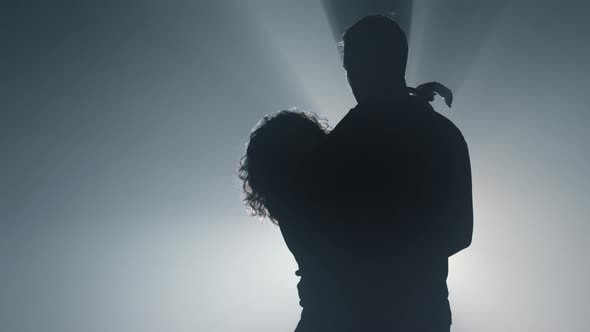 Silhouette of Sensual Couple Hugging Indoors
