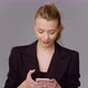 Stylish Businesswoman Browsing Smartphone in Studio - VideoHive Item for Sale