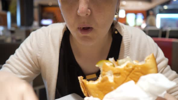 Woman Eating French Fries and Hamburger in Fast Food Restaurant Mouth Closeup