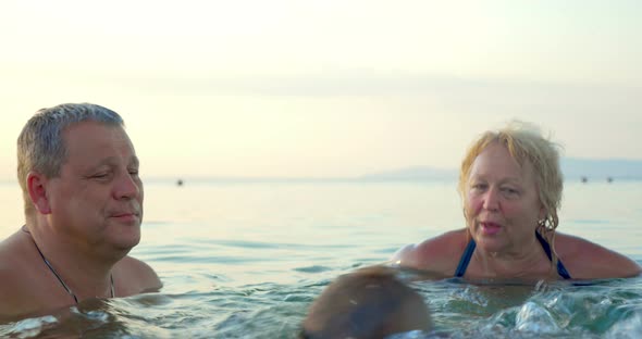 Grandparents Teaching Boy Swimming Underwater