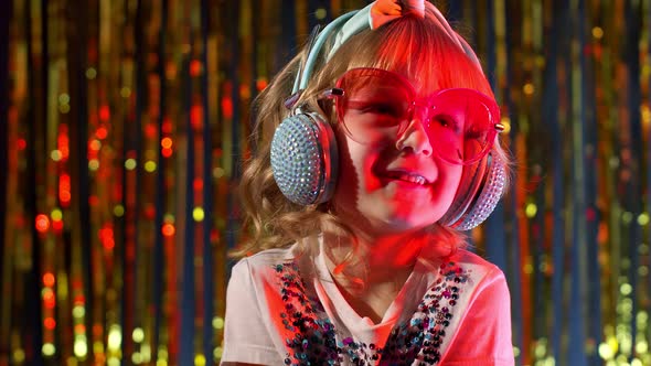 Portrait of Trendy Stylish Girl Looking at Camera Smiling Child Kid in Neon Light at Disco Club