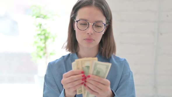 Young Woman Counting Dollars