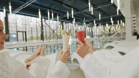 Happy Couple With Cocktails By Pool