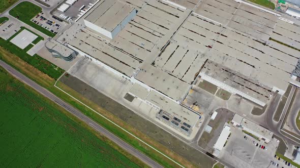 Industrial complex. Roofs of manufacture buildings on green field.