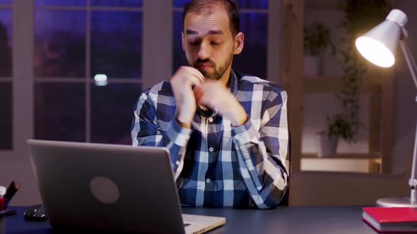 Exhausted Businessman Rubbing His Eyes and Temples