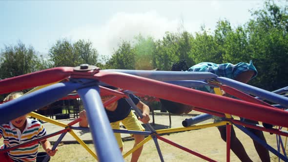 Schoolkids playing on dome climber in playground