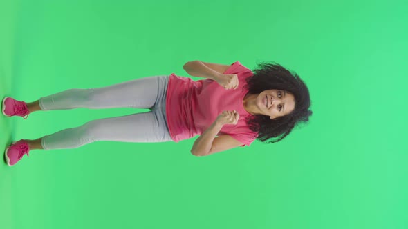 Portrait of Young Female African American Looking at Camera with Excitement and Anticipation Then